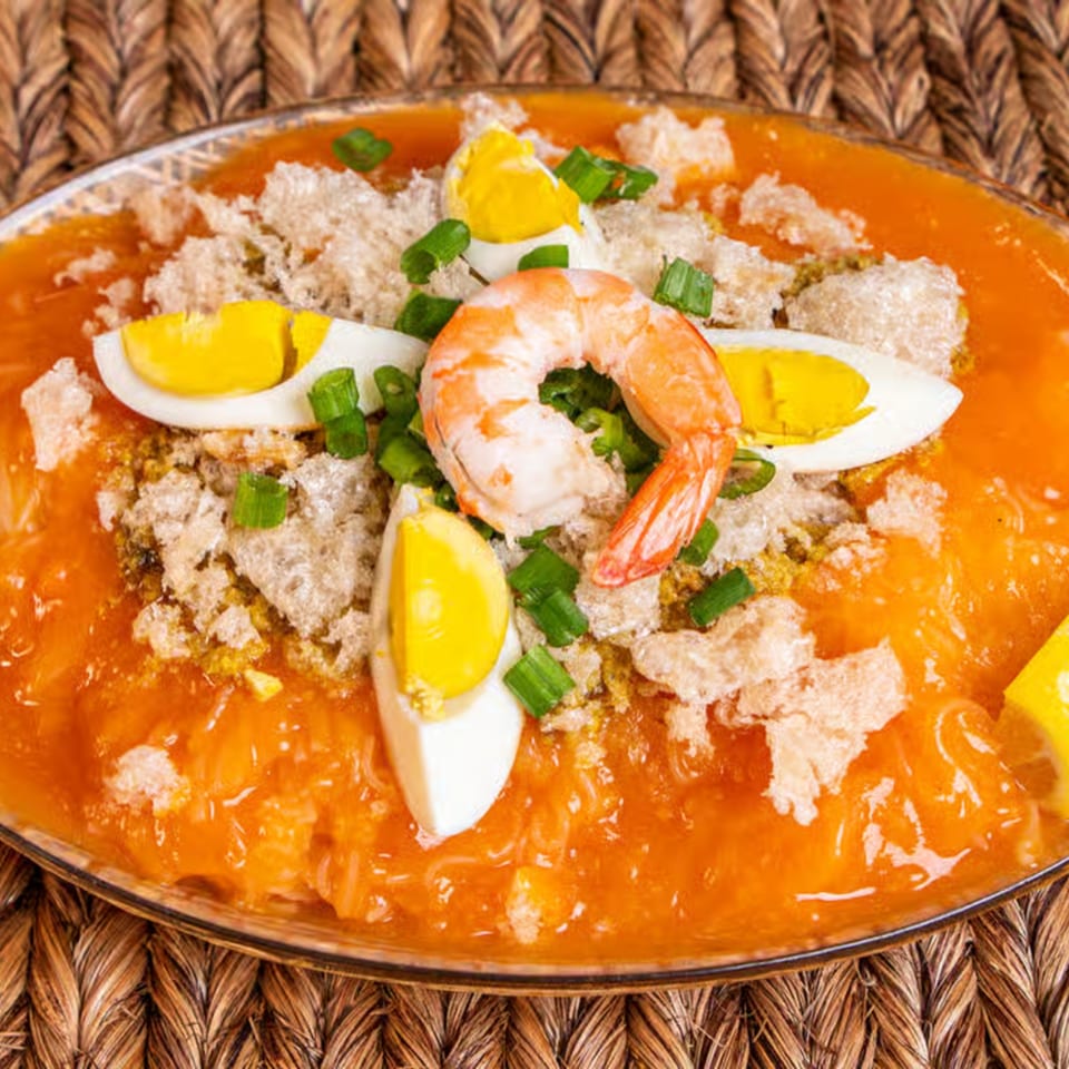 Lutong Bahay's Palabok, a Filipino noodle dish with orange sauce, shrimp, eggs, and chicharon.